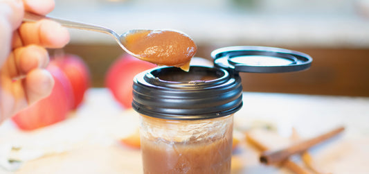 black recap mason jar lid with applesauce