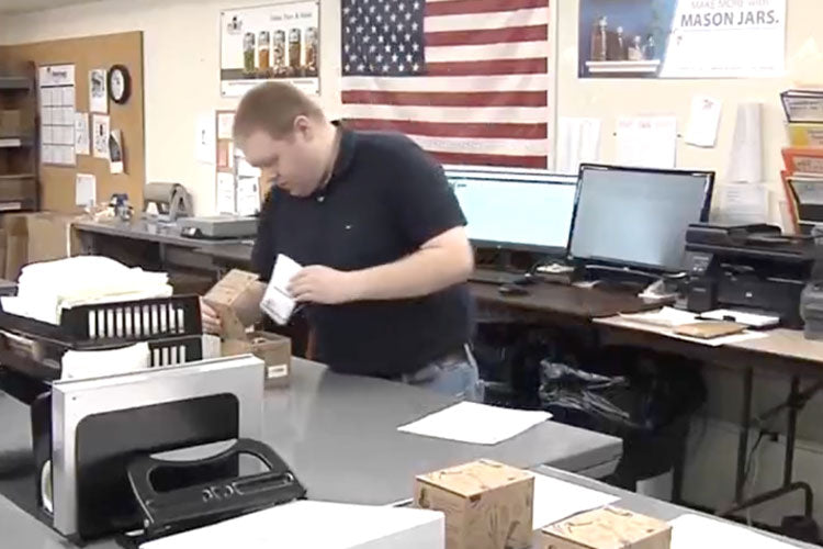 reCAP team member packing Mason jar products for shipment