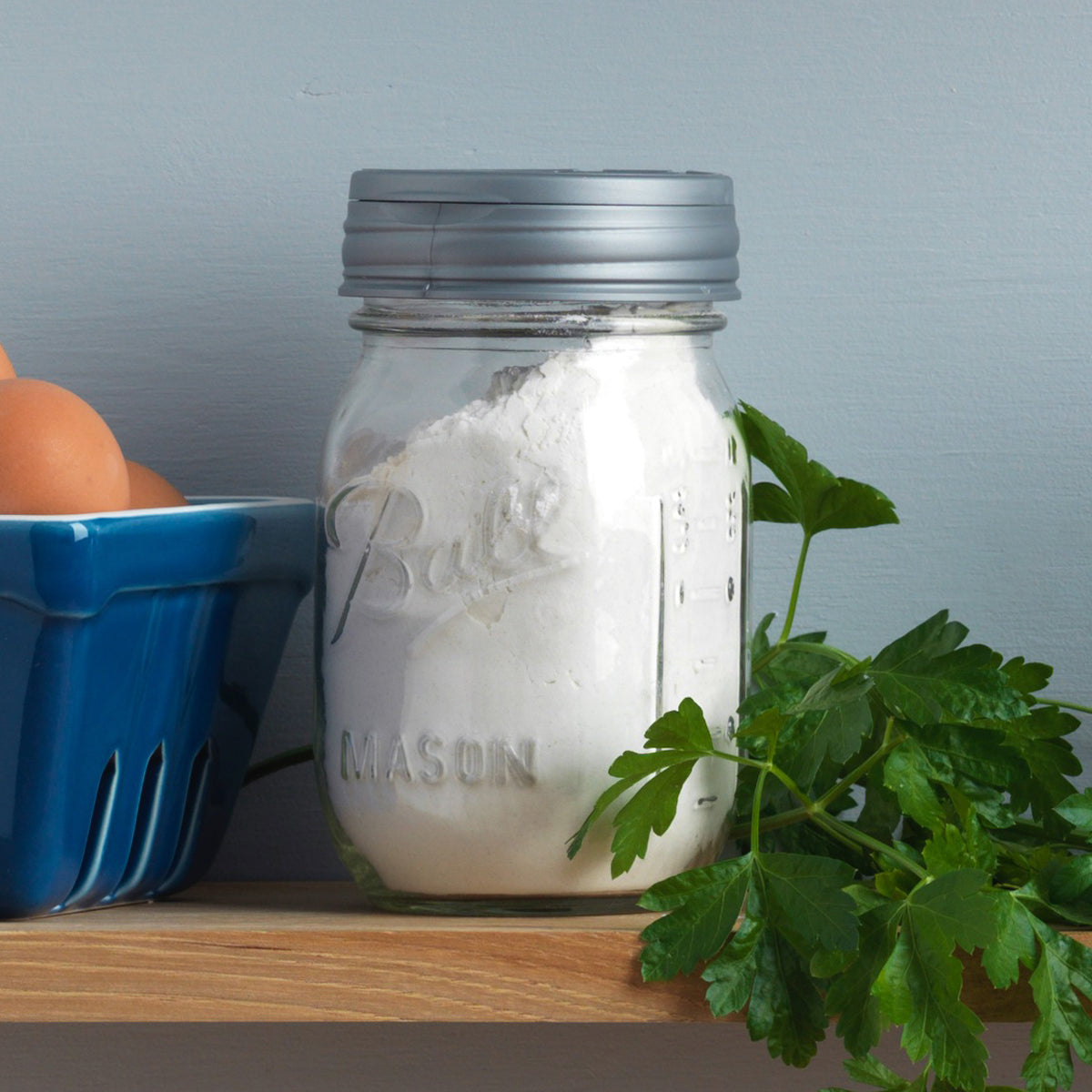 A jar a flour topped with a silver reCAP® Regular Mouth Mason Jar FLIP Top Lid