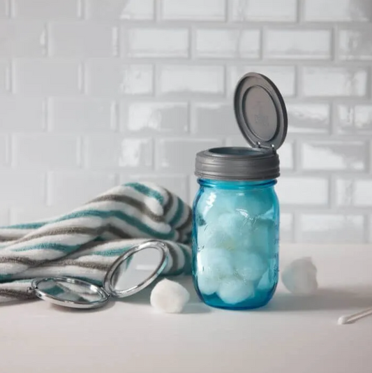 A jar full of cotton balls topped with a reCAP® Regular Mouth Mason Jar FLIP Top Lid