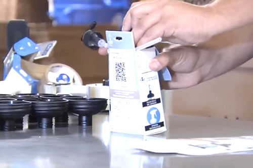 reCAP team member boxing up a reCAP Mason jar cap