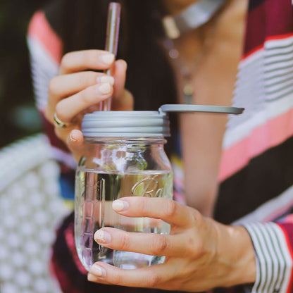 A Mason jar full of water topped with a reCAP® Regular Mouth Mason Jar FLIP Top Lid