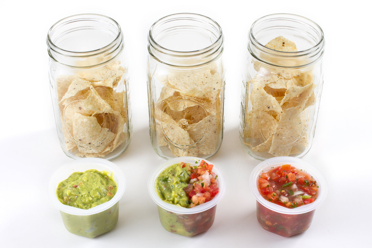 A picture of three wide mouth mason jars full of chips and Cuppow lids full of dip.