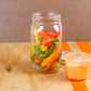 Wide-mouth Mason jar full of peppers with a Cuppow divider full of dip.