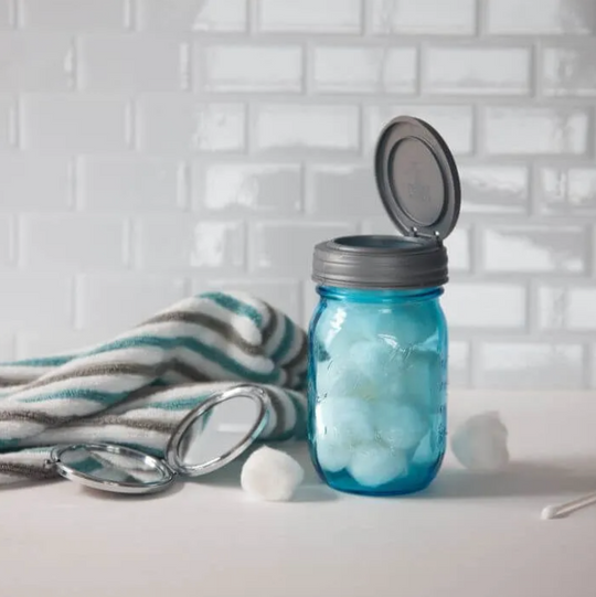 A jar full of cotton balls topped with a reCAP® Regular Mouth Mason Jar FLIP Top Lid