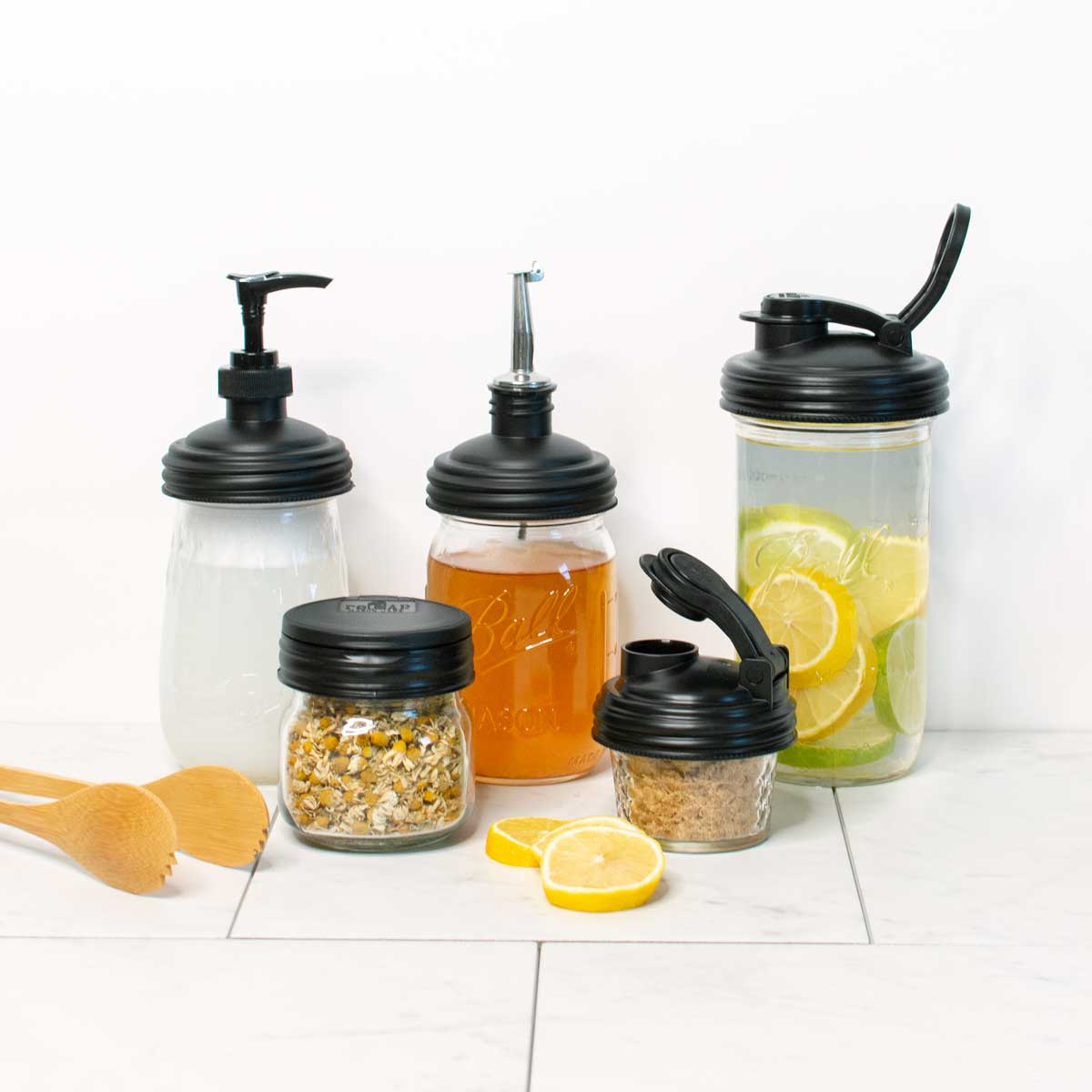 https://recapmasonjars.com/cdn/shop/products/refive-black-mason-jar-lids-in-kitchen.jpg?v=1677100300